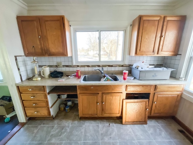 kitchen featuring decorative backsplash, sink, and a wealth of natural light