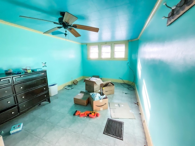 interior space featuring ceiling fan and ornamental molding