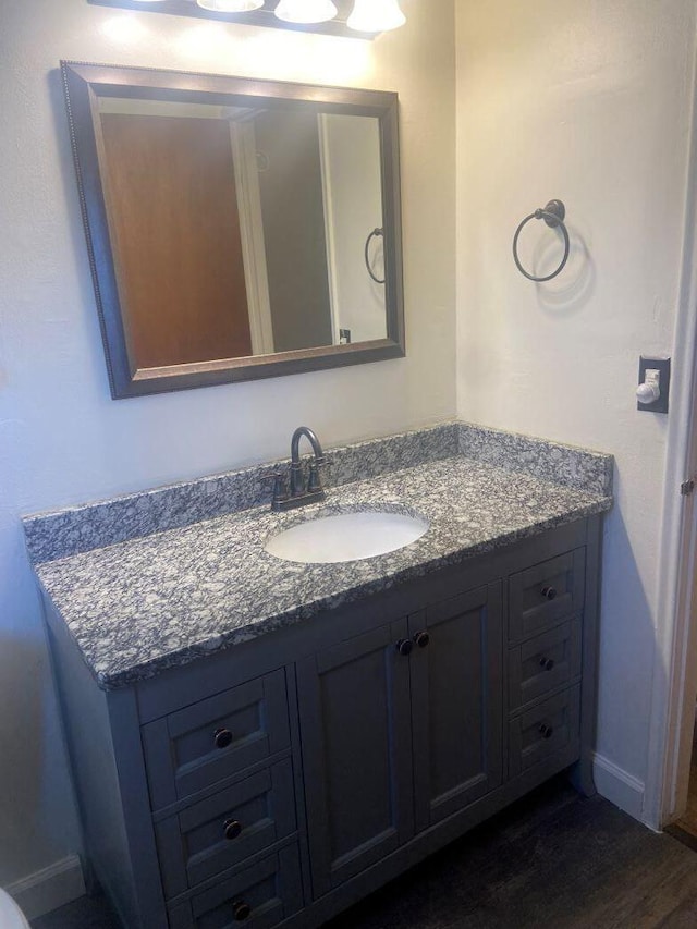 bathroom with vanity and hardwood / wood-style floors