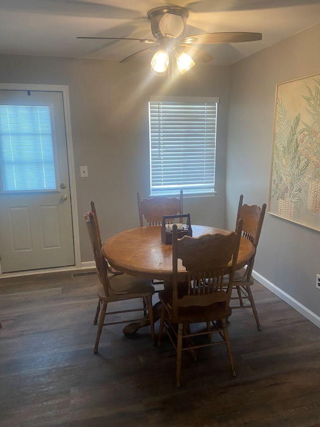 dining room with dark hardwood / wood-style floors and ceiling fan