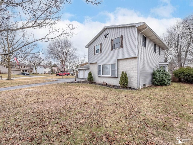 view of property exterior with a garage and a yard