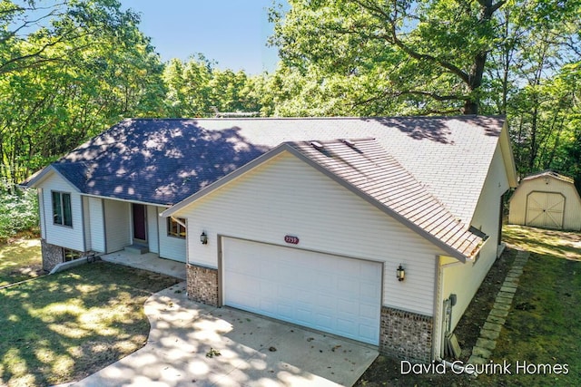 single story home featuring a storage unit and a garage