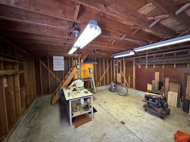 basement featuring wooden walls