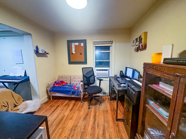 office with light hardwood / wood-style floors and cooling unit