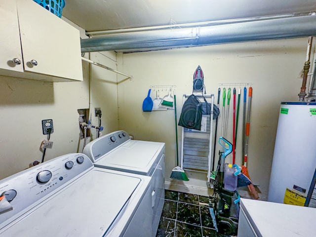 washroom with cabinets, gas water heater, and independent washer and dryer