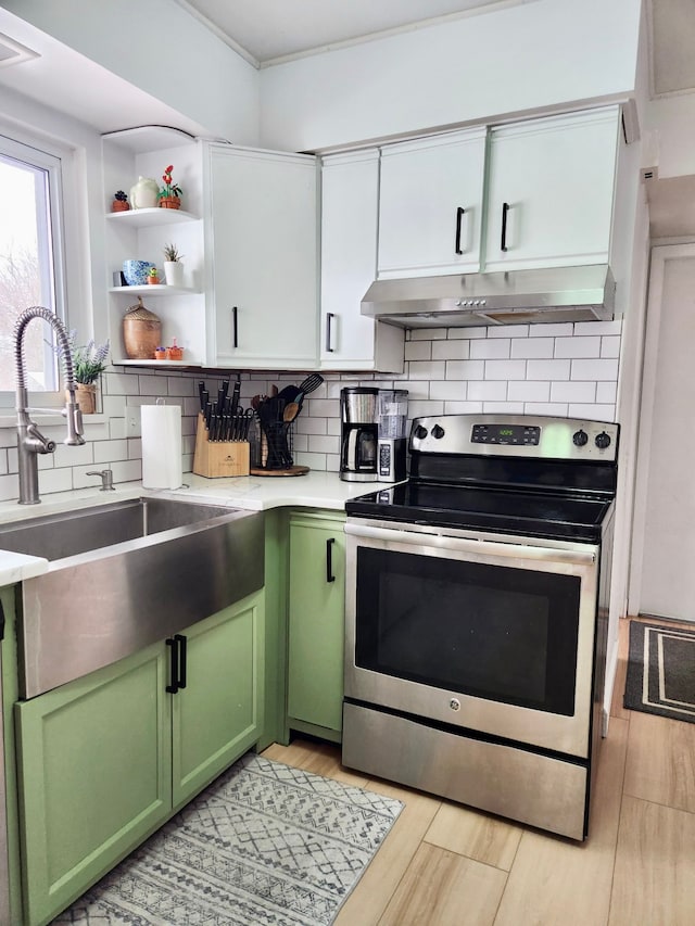 kitchen featuring sink, backsplash, white cabinets, green cabinetry, and stainless steel electric stove