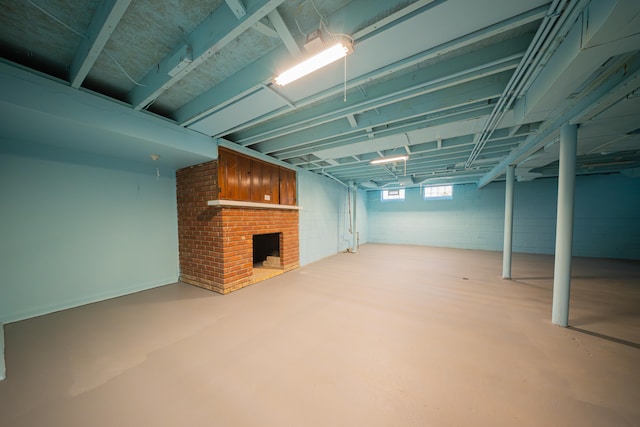 basement featuring a brick fireplace