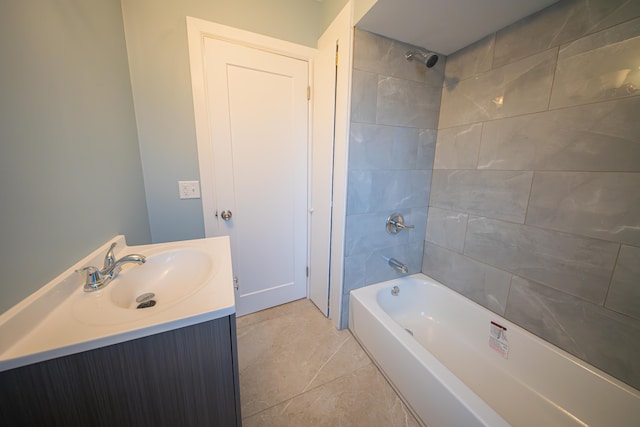 bathroom featuring vanity, tile patterned flooring, and tiled shower / bath combo