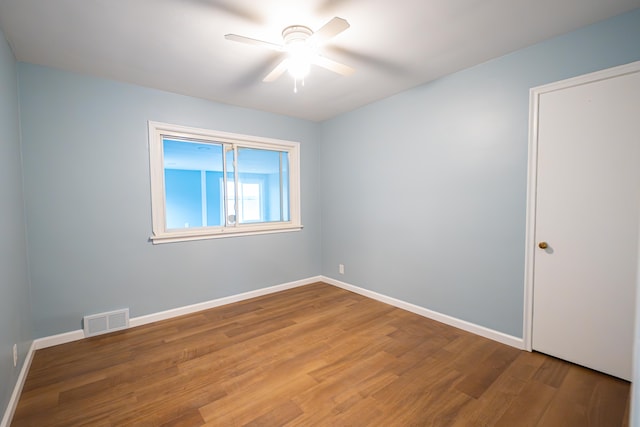 spare room featuring ceiling fan and hardwood / wood-style flooring