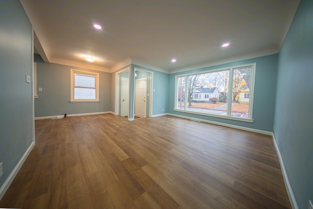 unfurnished living room with dark hardwood / wood-style flooring