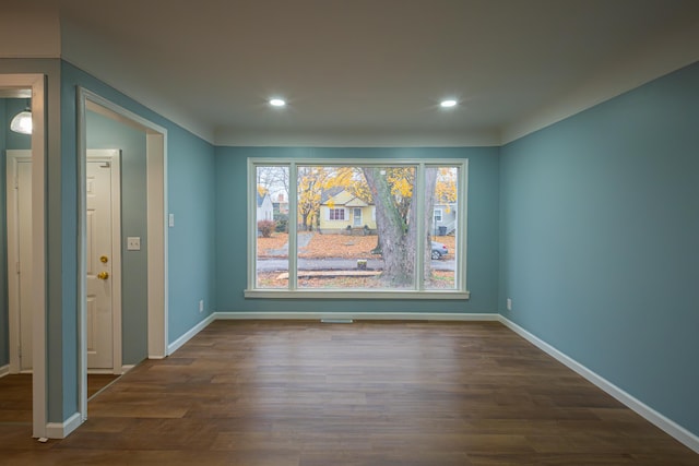 unfurnished dining area with dark wood-type flooring