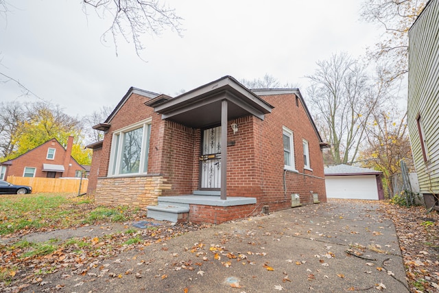 view of front facade featuring a garage and an outbuilding