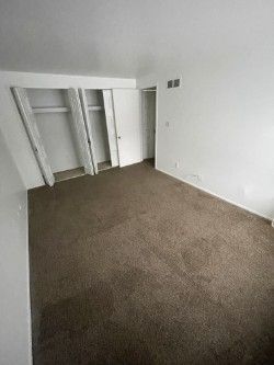 unfurnished bedroom featuring dark colored carpet