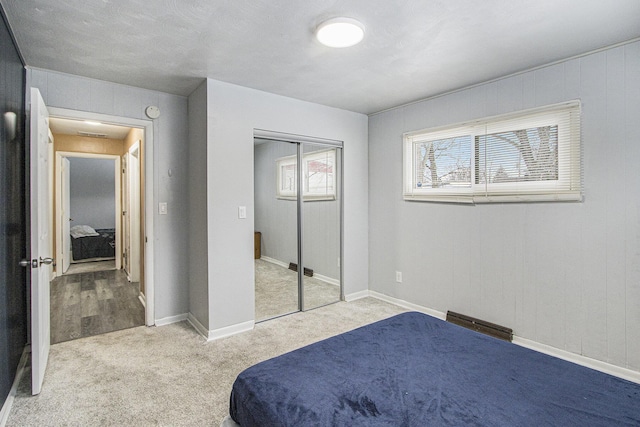 bedroom with light carpet and a closet