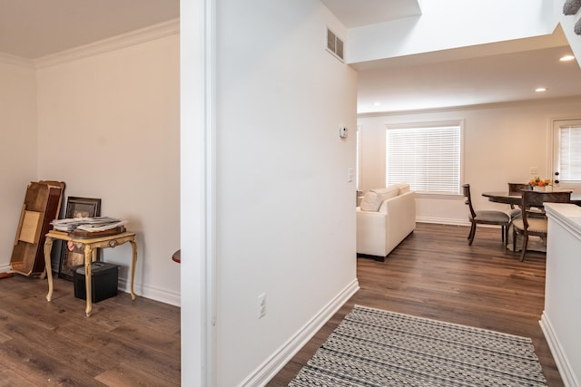 corridor with ornamental molding and dark hardwood / wood-style flooring