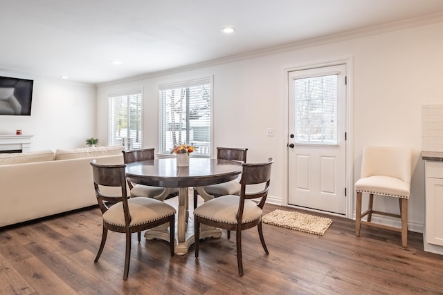 dining room with dark hardwood / wood-style floors and ornamental molding