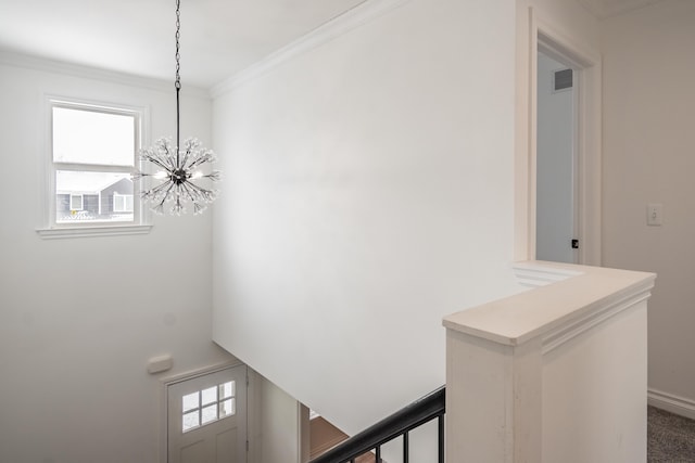 interior space with crown molding and a chandelier