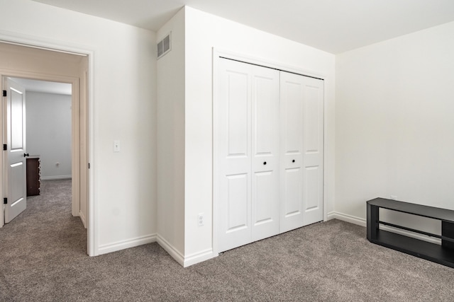 unfurnished bedroom featuring a closet and carpet floors