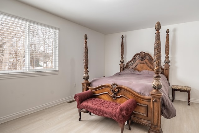 bedroom with multiple windows and light hardwood / wood-style floors