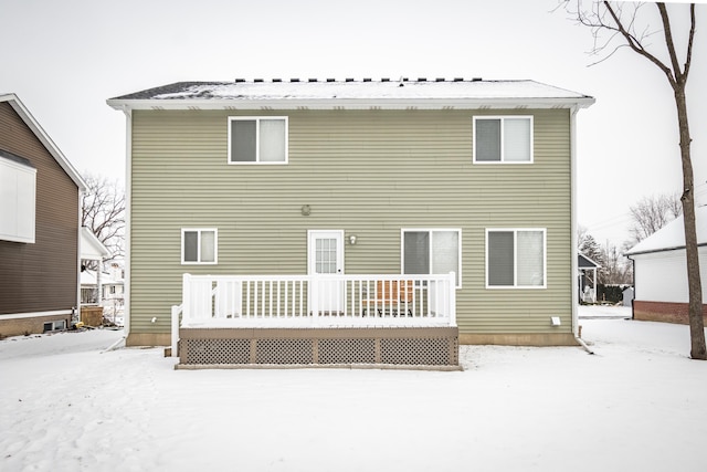 snow covered rear of property featuring a wooden deck