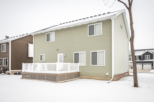 snow covered property with a deck