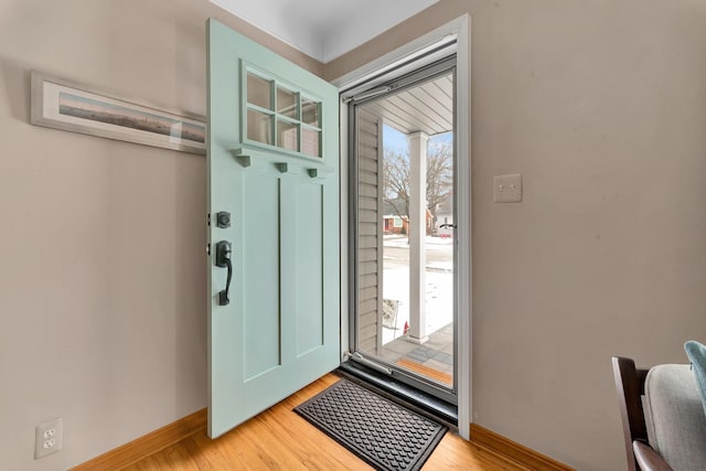 doorway to outside with light hardwood / wood-style flooring and plenty of natural light