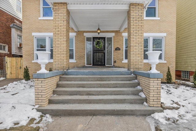 view of snow covered property entrance