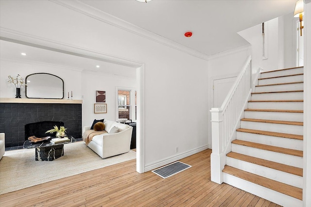 stairway featuring hardwood / wood-style flooring and crown molding