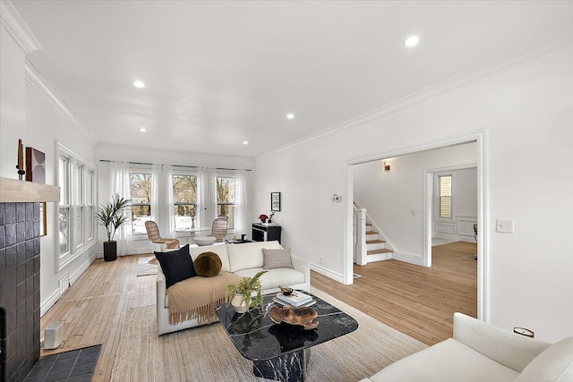 living room featuring ornamental molding and light hardwood / wood-style flooring