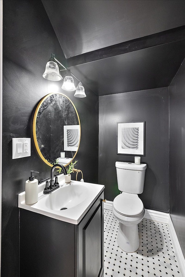 bathroom featuring vanity, tile patterned floors, and toilet