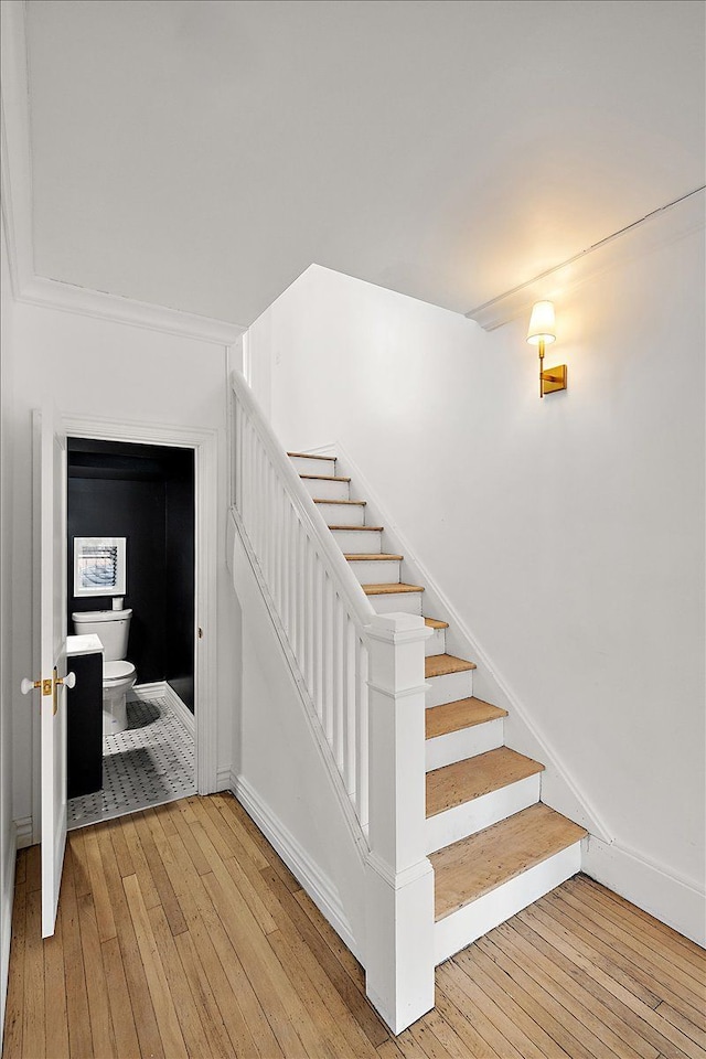 stairs featuring hardwood / wood-style floors