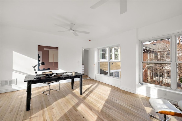 office with ceiling fan and light wood-type flooring