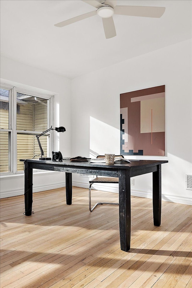 unfurnished office featuring ceiling fan and light wood-type flooring