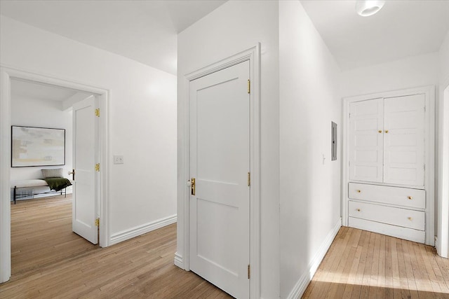 hallway with light hardwood / wood-style floors