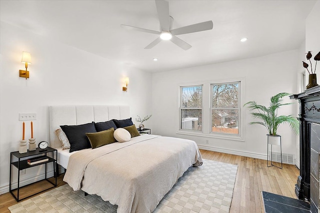 bedroom featuring light hardwood / wood-style flooring and ceiling fan