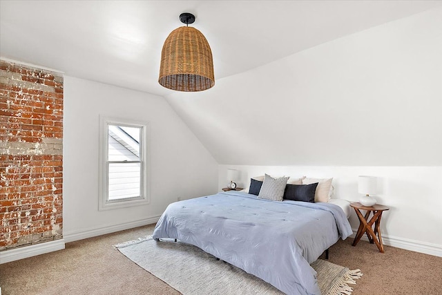 bedroom with lofted ceiling and light carpet