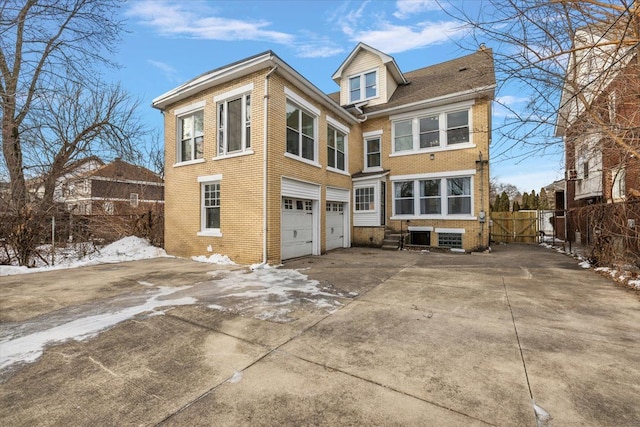 snow covered house with a garage