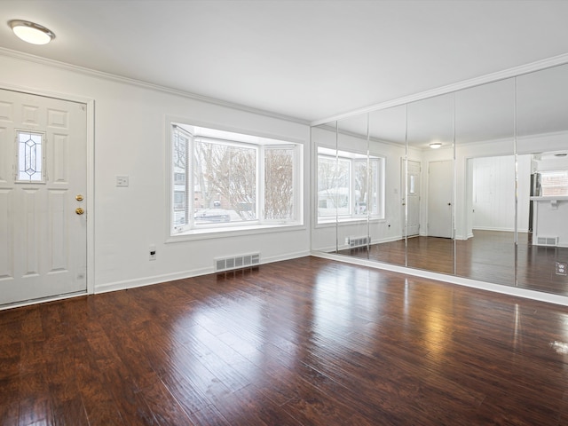 entryway featuring crown molding and dark hardwood / wood-style floors