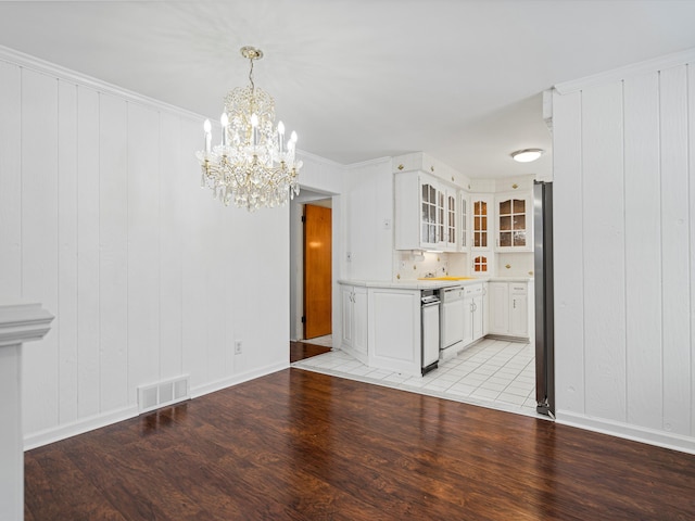 kitchen with dishwasher, pendant lighting, stainless steel refrigerator, light hardwood / wood-style flooring, and white cabinets