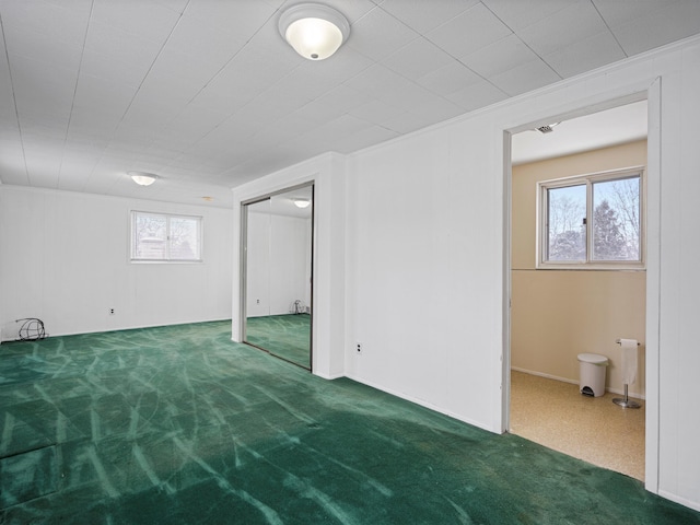 basement featuring carpet flooring and crown molding