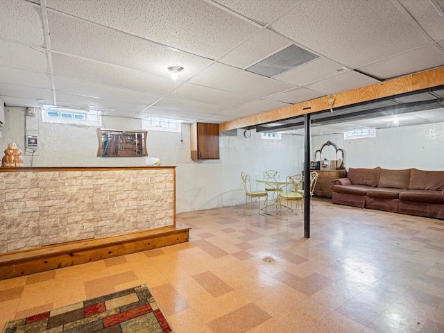 basement with a paneled ceiling