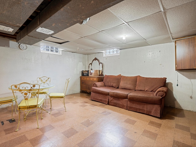 living room featuring a paneled ceiling