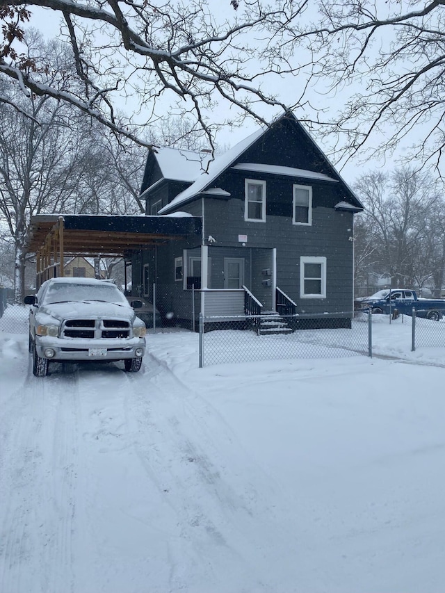 view of front of home featuring a carport and fence