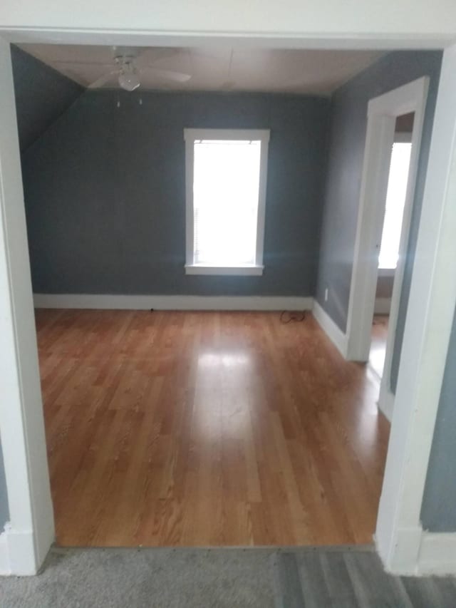 2908 Hoyt St, Muskegon Heights, MI 49444 - additional living space with wood finished floors, ceiling fan, and baseboards