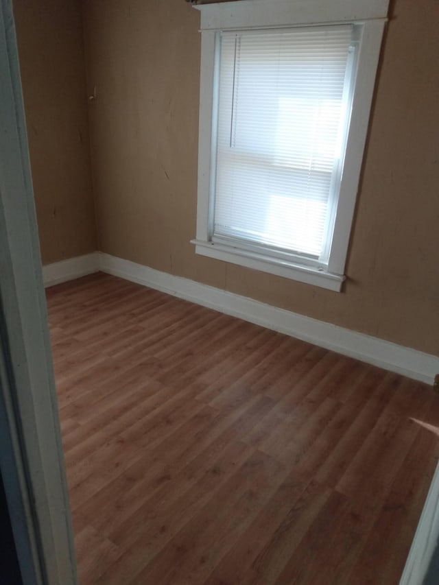 2908 Hoyt St, Muskegon Heights, MI 49444 - spare room with baseboards and wood finished floors