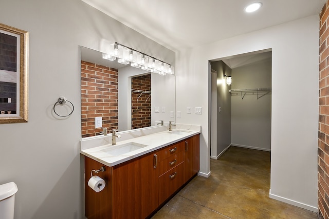 bathroom featuring concrete floors, toilet, and vanity