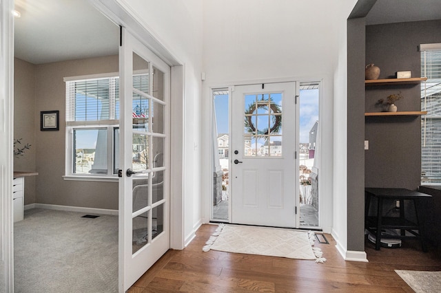 entrance foyer with french doors and dark hardwood / wood-style floors