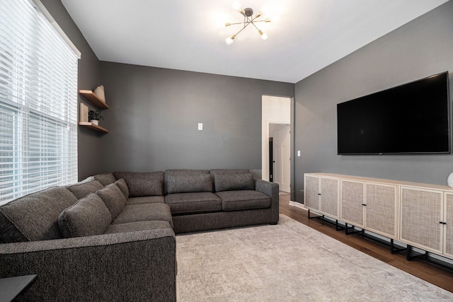 living room with wood-type flooring and a chandelier