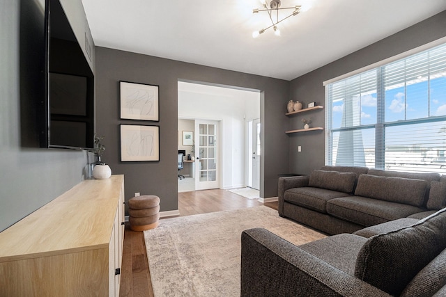 living room with light wood-type flooring and french doors