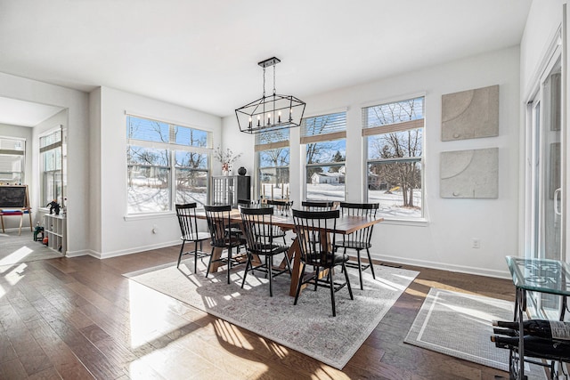 dining area featuring a notable chandelier and dark hardwood / wood-style flooring